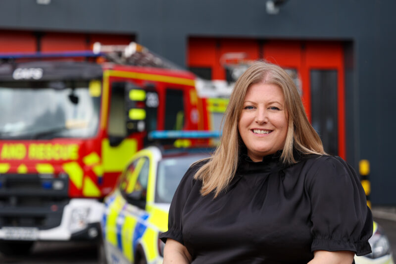 PCC Donna Jones smiling wearing a black dress outside the new Cosham Police and Fire Station