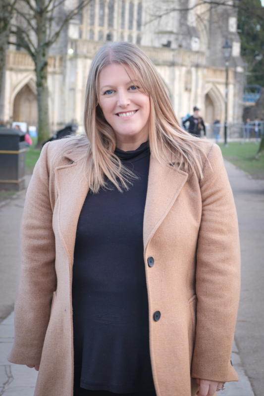 PCC Donna Jones in a beige coat and black dress smiling at the camera